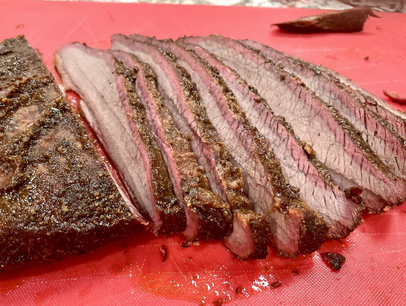 Sliced Texas brisket with smoke ring on butcher paper