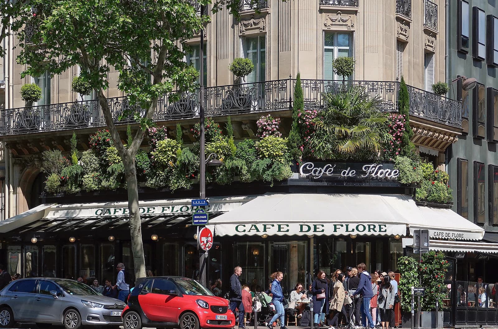 The terrace of a French bistro with outdoor seating and classic Parisian ambiance