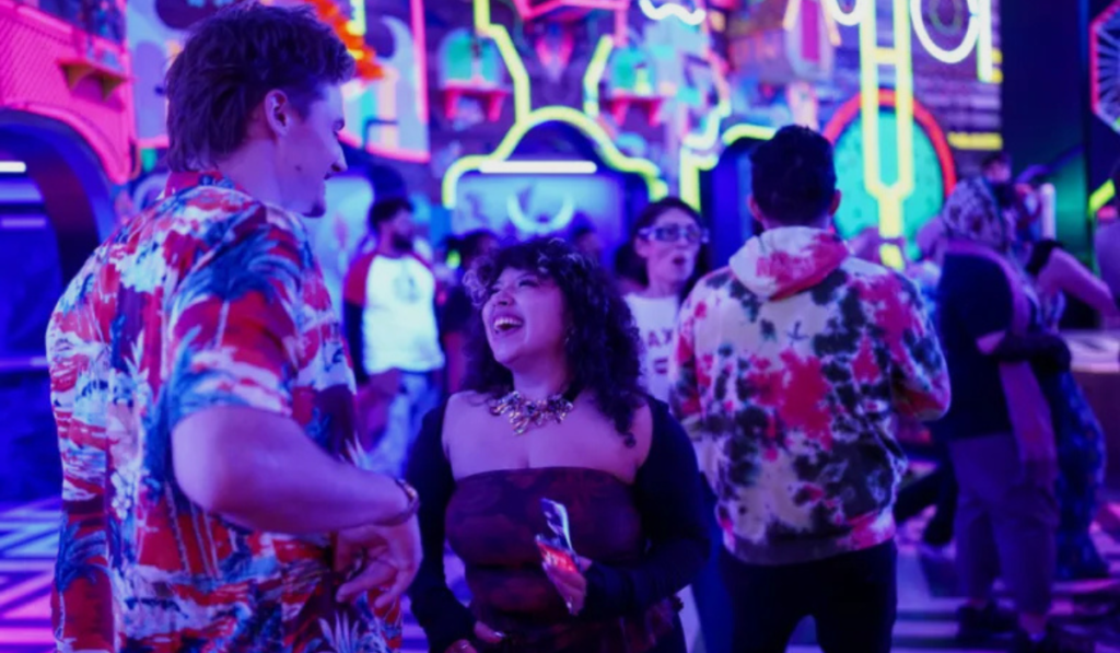appy couple exploring the vibrant neon art rooms at Meow Wolf Grapevine The Real Unreal